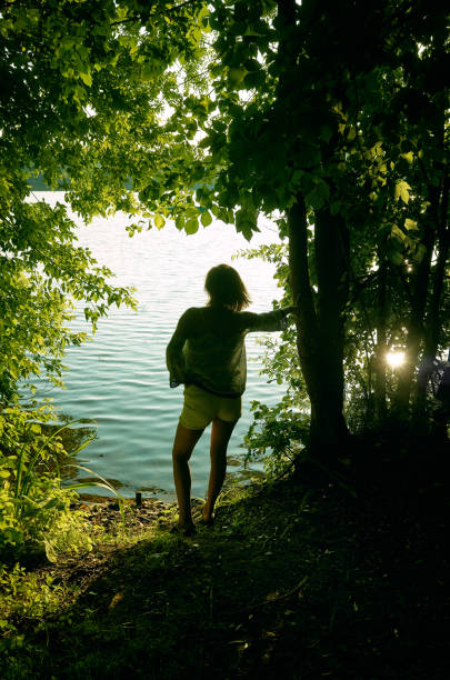 istock One girl standing on coast 864728996