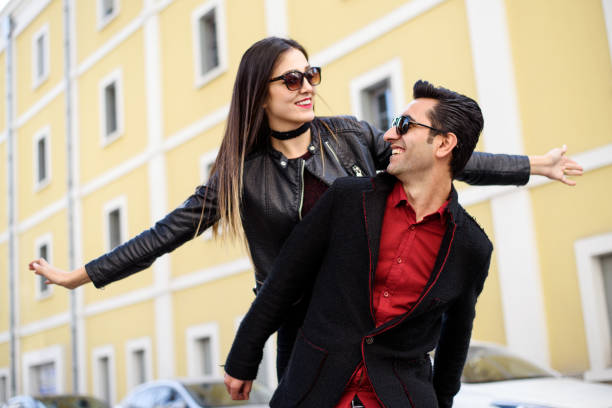 istock Young man piggyback her girlfriend 864735506