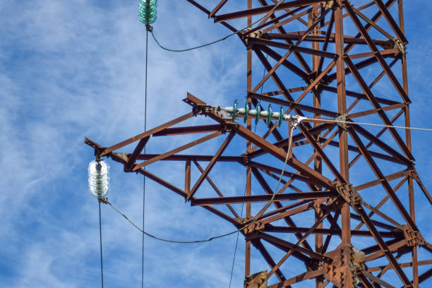 istock Supports high-voltage power lines against the blue sky with clouds. Electrical industry 864735738
