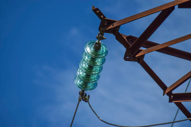 Glass prefabricated high voltage insulators on poles high-voltage power lines. Electrical industry.