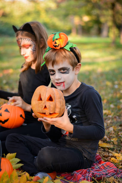 istock Children in autumn park at Halloween 864746194