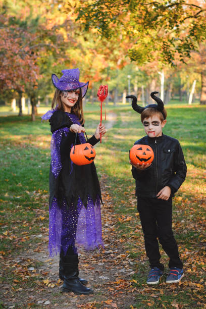 istock Children in autumn park at Halloween 864753052