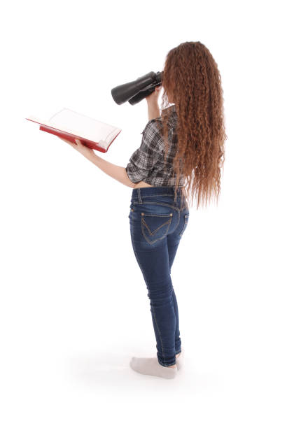 istock Attractive smiling young girl with binoculars 864756746