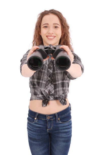 istock Attractive smiling young girl with binoculars 864756816