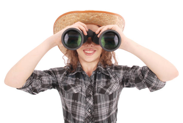 istock Attractive smiling young girl with binoculars 864757052