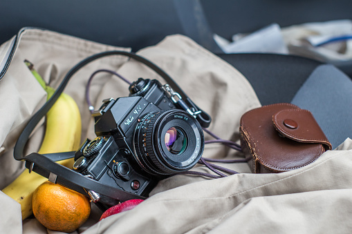 A trip for photo shoot, it needs camera and light meter. Also, fbanana and orange pack for food.
