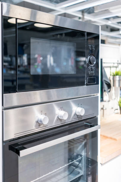 istock Closed up silver black wall oven with built-in microwave. Modern kitchen electric appliance. 864768590