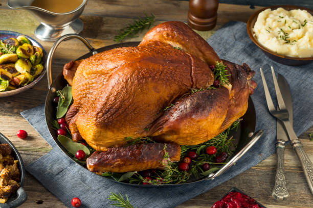organic homemade smoked turkey dinner for thanksgiving - peru imagens e fotografias de stock