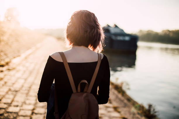 istock Beautiful woman by the river 864777362