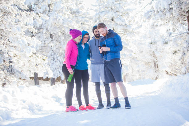 istock Sportspeople taking break on winter work out 864793392