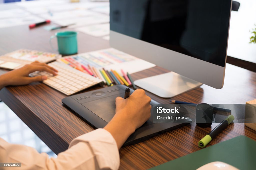 interior designer drawing on graphic tablet at office. artist working with computer at workplace. photographer retouch photo. design, creativity, idea Art Stock Photo