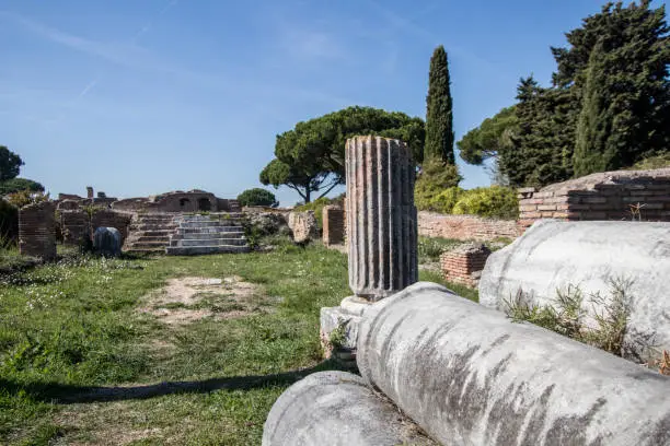 Photo of Columns from ancient Rome abandoned in old ruins place. Ostia Antica details