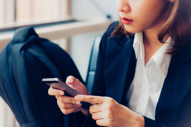 istock Business woman using smartphone checking e-nail, message today. Concept people and technology. Business woman sit by the window and holding mobile phone in her hand. Business people in relax time. 864801396