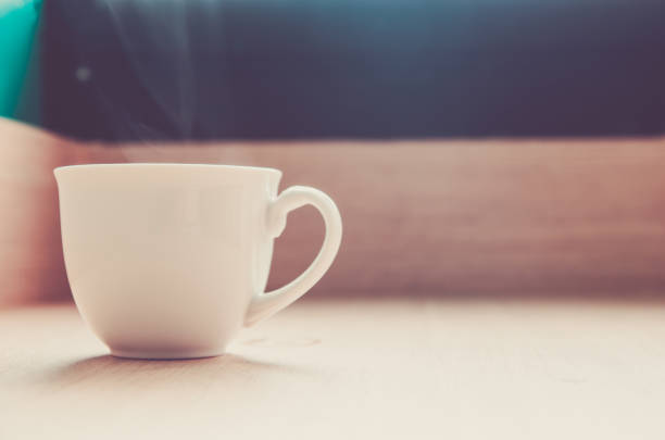 istock Coffee cup and saucer on a wooden table . 864804842