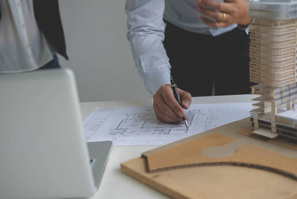 istock Hands of Engineer Working on Blueprint. Construction Concept. Engineering Tools.Vintage Tone Retro Filter Effect. Soft Focus(selective focus) 864805416