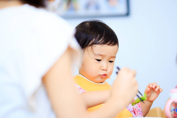 istock Cute baby with a meal 864808290