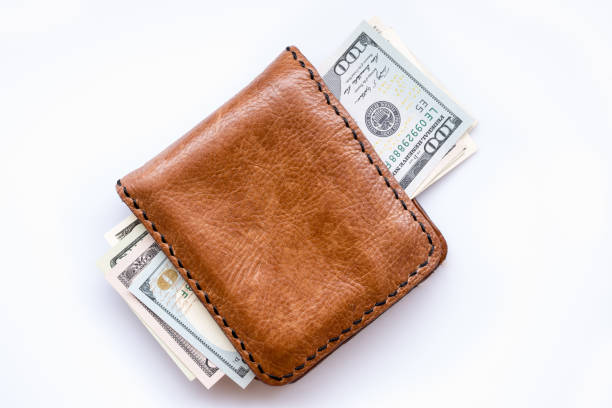 istock dollars bills in wallet on white 864811424