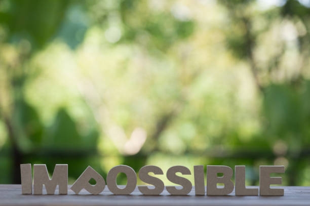 istock The letters word IMPOSSIBLE in motivation meaning of impossible make it possible concept. On wood background. 864831198