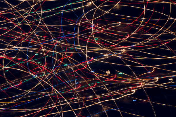 istock Abstract image of colorful lights long exposure on black background. 864831320