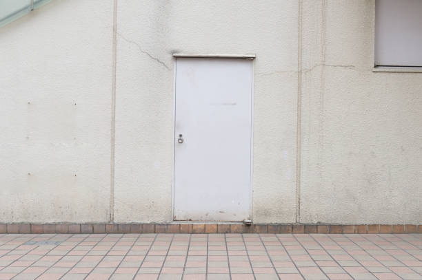 istock sidewalk by street wall & door 864837902