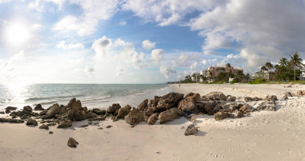 Paradise like Naples beach at sunset, south Florida, USA. Long extension beaches at Naples in south Florida, in a sunny day which turned into darkness in few minutes before it rains during this tropical weather season. marco island stock pictures, royalty-free photos & images