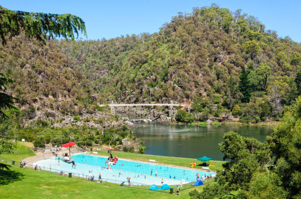 First Basin in the Cataract Gorge Reserve - Launceston Launceston, Tasmania, Australia - February 1, 2014: The First Basin in the Cataract Gorge Reserve features a swimming pool, a chairlift and a footbridge launceston tasmania stock pictures, royalty-free photos & images