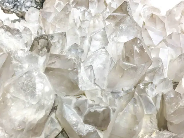 White Quartz Crystal cluster on black background. It's selective focus.