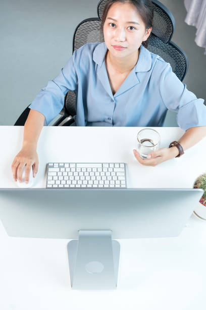 istock asian business woman looking at computer screen 864857754