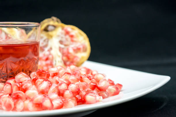 istock open pomegranade composition with a glass full of pomegranade juice 864860860