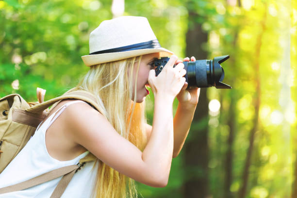 istock Female photographer with a camera outside 864865692