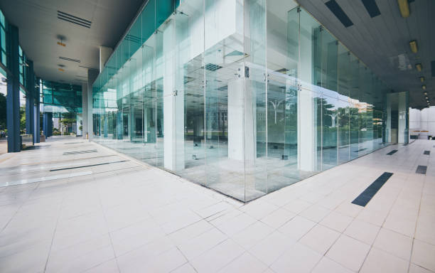 istock Modern empty office buildings with glass wall and empty pavement . 864866160