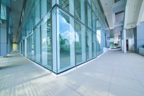 istock Modern empty office buildings with glass wall and empty pavement . 864866210