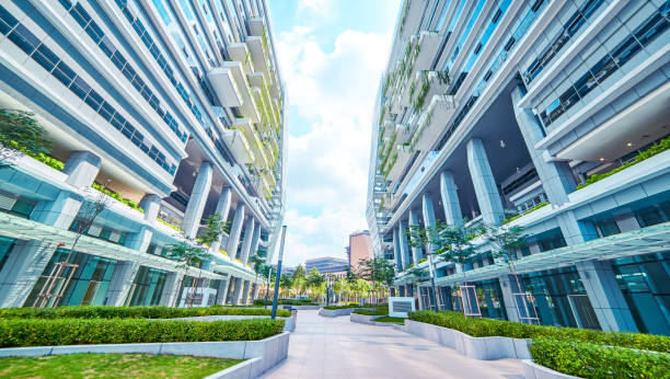istock Low angle perspective view of empty pavement and modern office building with green eco concept balcony . 864866230