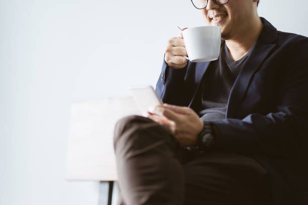 istock Coffee in businessman hand with with smartphone , selective focusing . 864866444