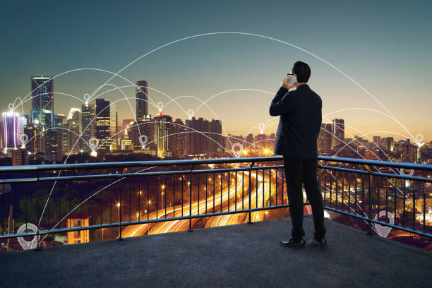 istock Businessman using phone on open terrace , modern city with internet connect with hotspot in downtown concept  background . 864866548