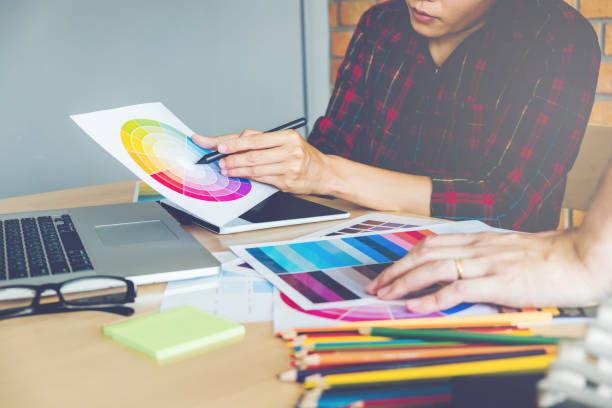 istock Two Graphic designer drawing on graphics tablet and color palette guide at workplace 864893040