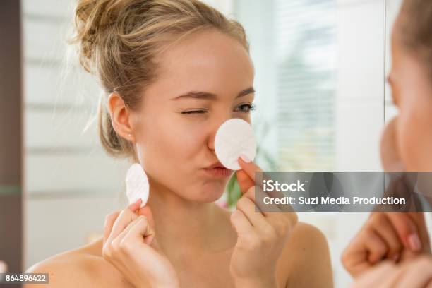 Young Beautiful Woman Cleaning Her Face Skin With Cotton Pad Stock Photo - Download Image Now