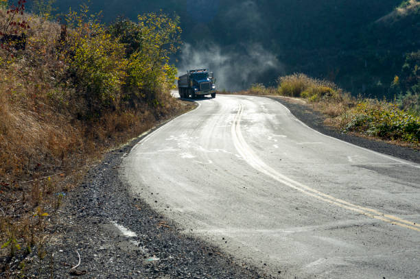 istock Dump Truck Moving through Corner Rural Oregon Road 864903932