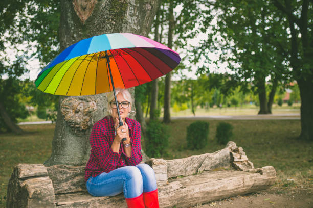 istock The old couple in the rain with umbrellas 864907914