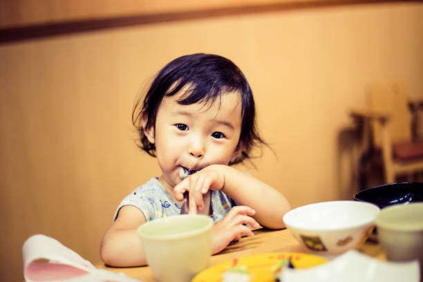 istock Cute baby with a meal 864908284