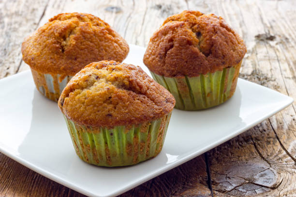 istock Muffins on a wooden table 864910760