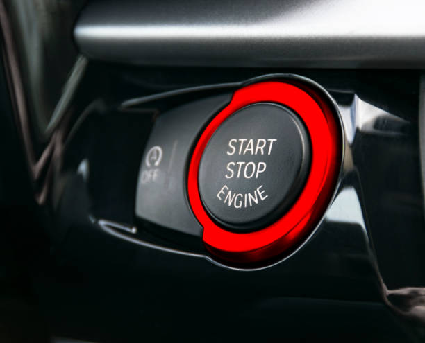 istock Car dashboard with focus on red engine start stop button, car interior details 864911038