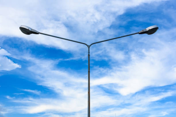 istock Electric street light pole on blue vivid sky in day light. 864911926