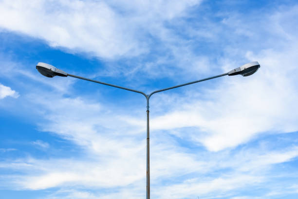 istock Electric street light pole on blue vivid sky in day light. 864912026