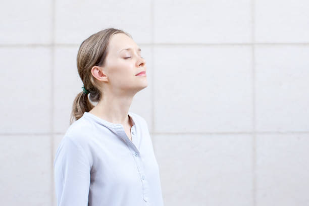 istock Serene young woman with closed eyes meditating 864912120