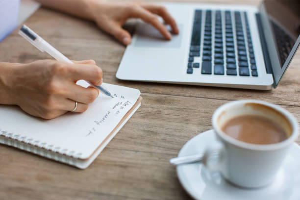 istock Cropped View of Lady Working on Laptop in Cafe 864912182