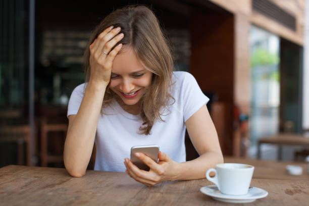 istock Emotional Lady Using Smartphone in Outdoor Cafe 864912224