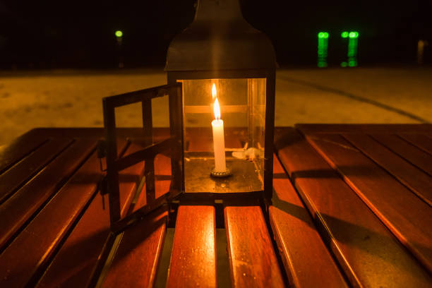 istock A candle lamp on a table by the sea at night. 864918514