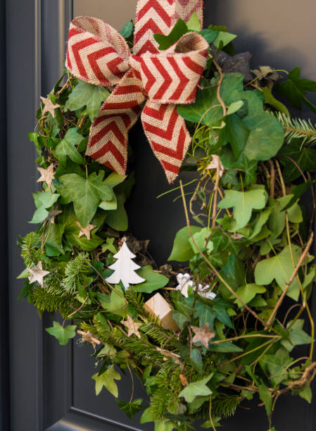 istock Front door with a Christmas wreath and bows. 864921238