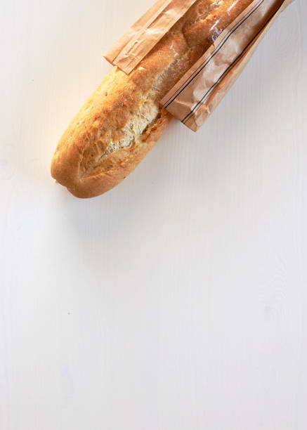 istock French bread baguette on wood table top white background 864921742